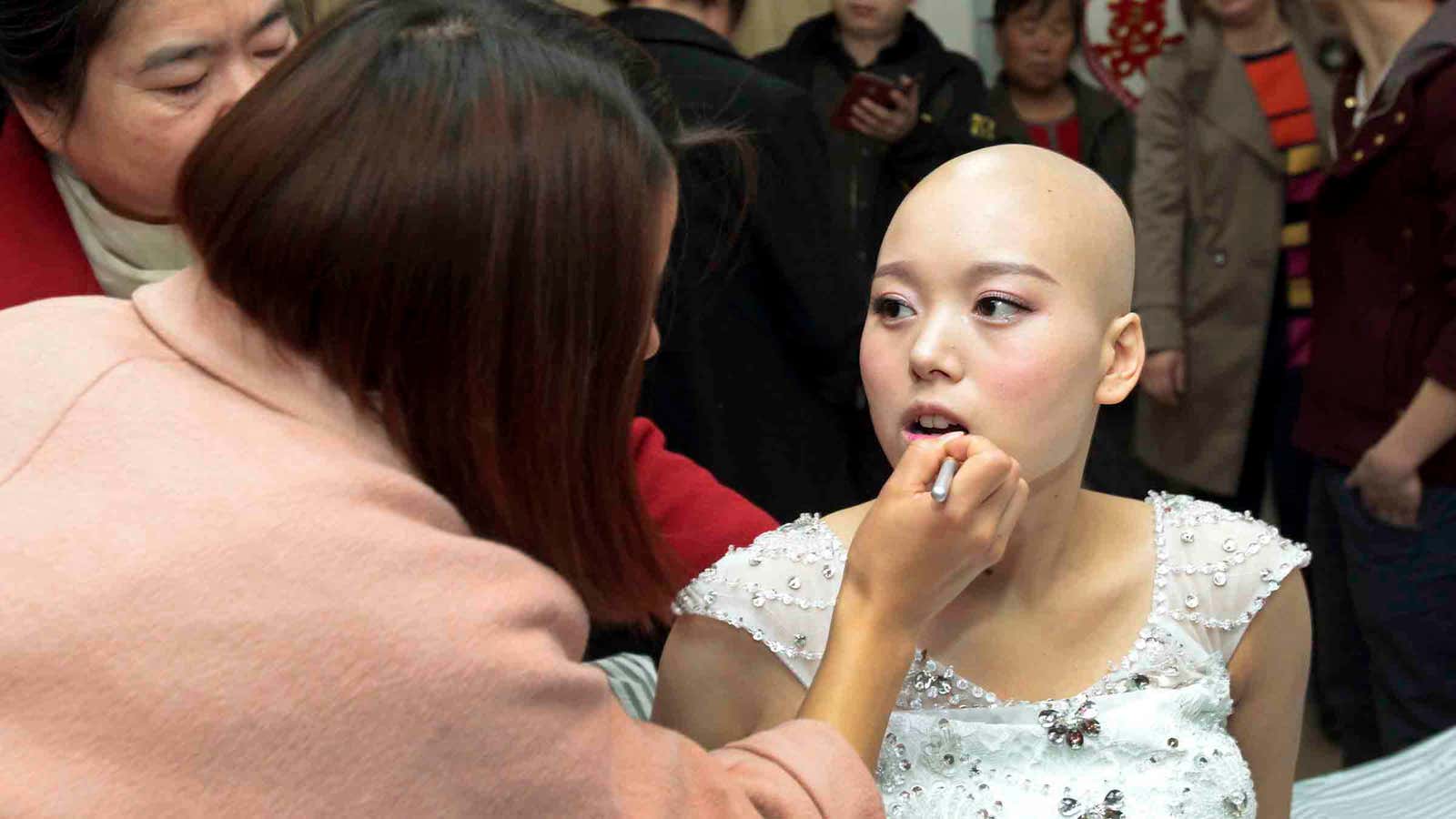 A Chinese cancer patient gets made up before her wedding.