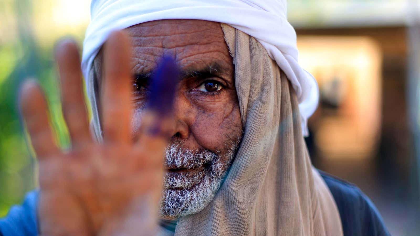 An Egyptian man shows his inked finger after voting on his country’s new constitution.