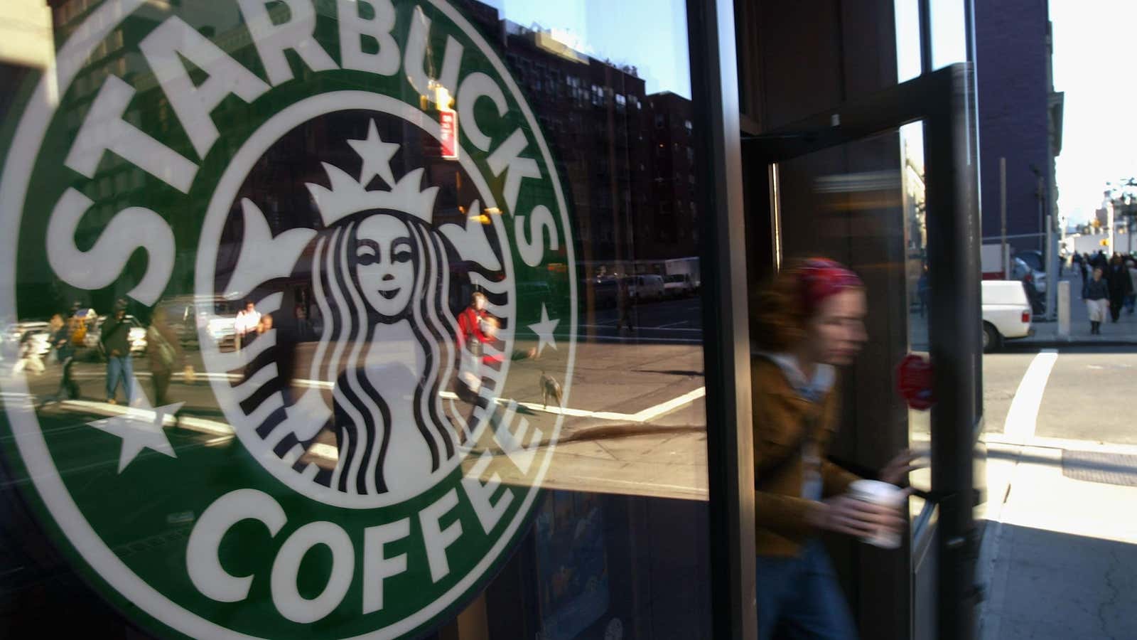 A person walks out of a Starbucks location in New York City. 