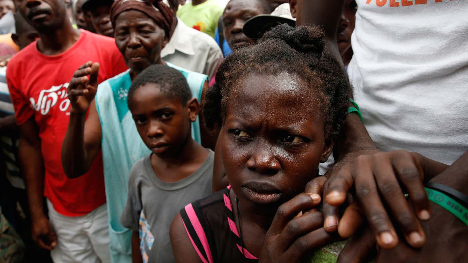 Haitians wait for food after the destruction of Hurricane Matthew.