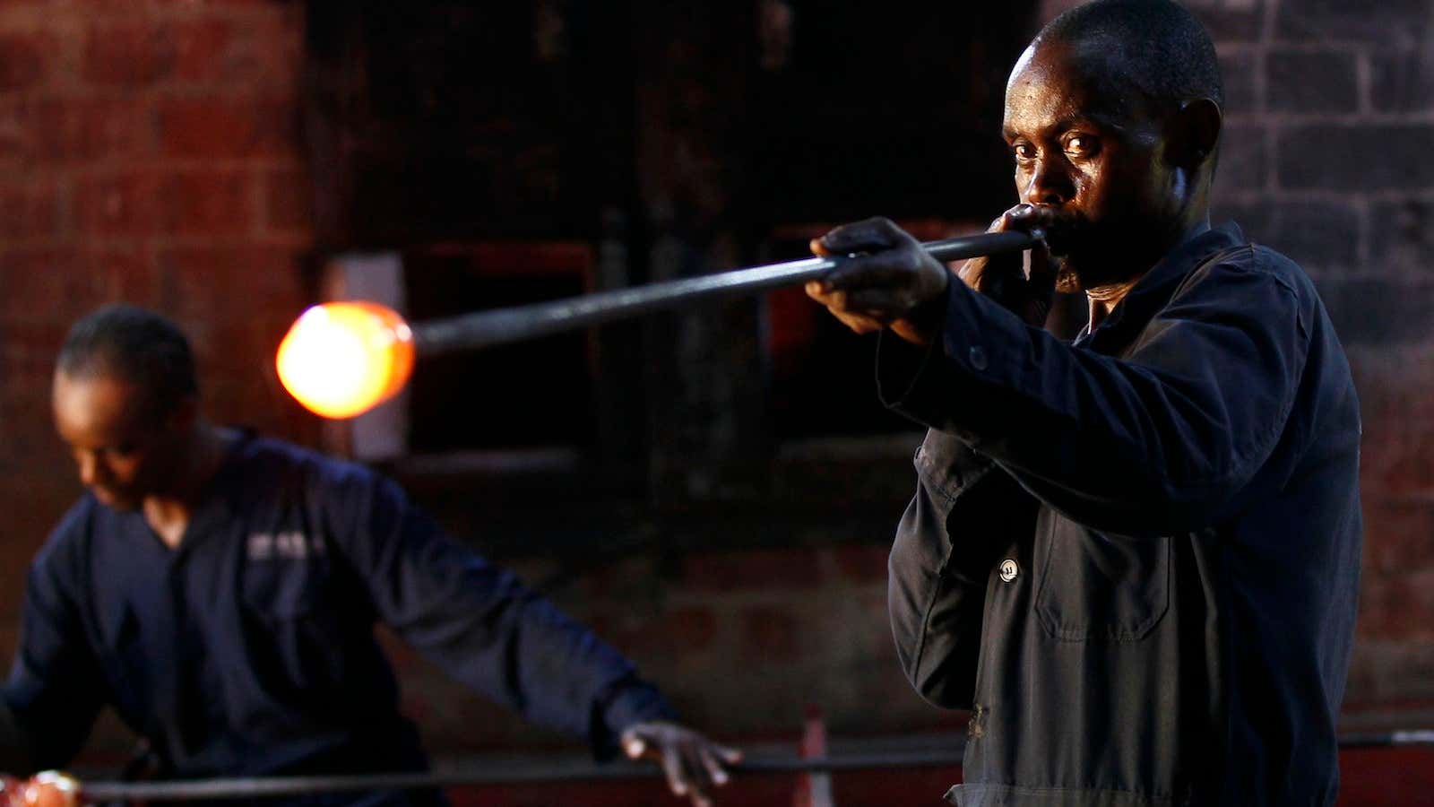 An artisan blows a bubble from heated glass at the Kitengela Hot Glass studio on the outskirts of Nairobi.