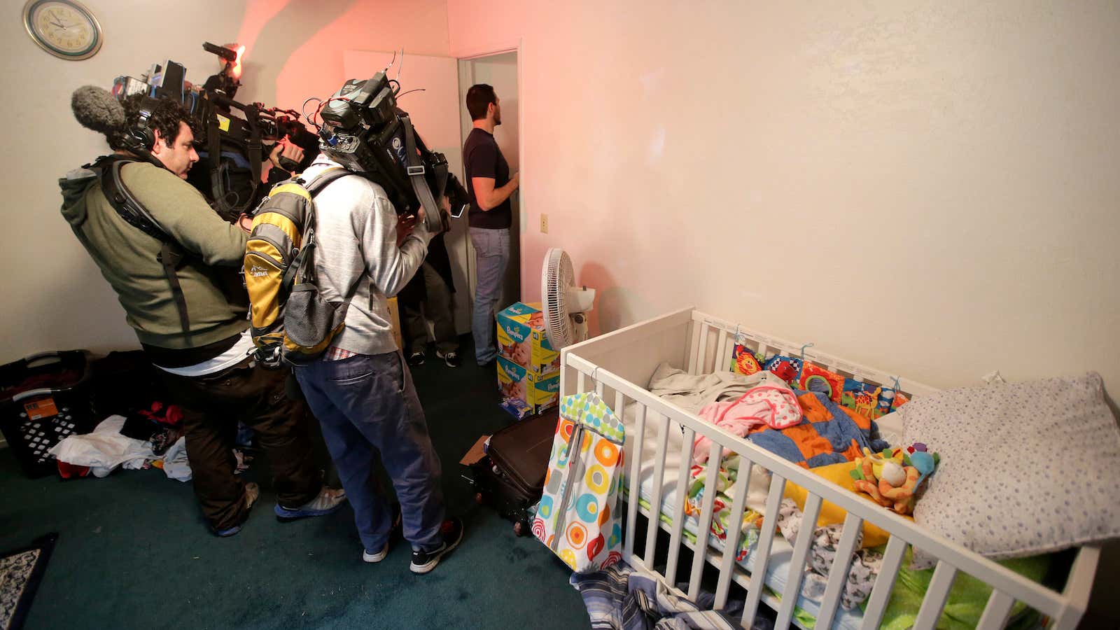 Members of the media crowd into a child’s room in an apartment in Redlands, Calif., shared by San Bernardino shooting rampage suspects Syed Farook and…