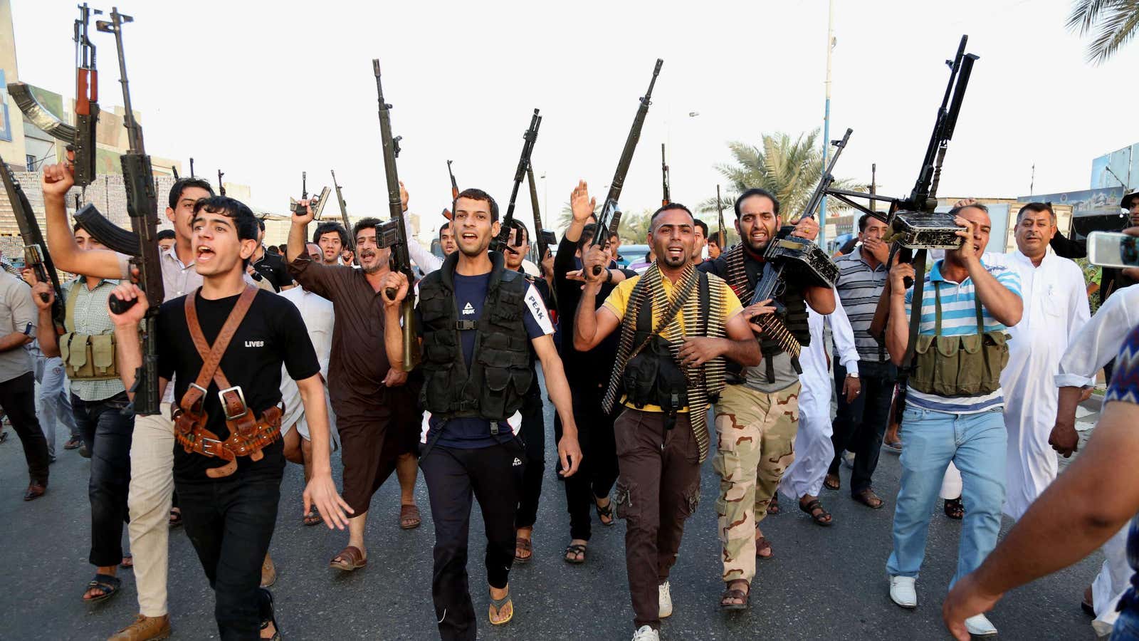 Shiite fighters in Baghdad’s Sadr City prepare for action.