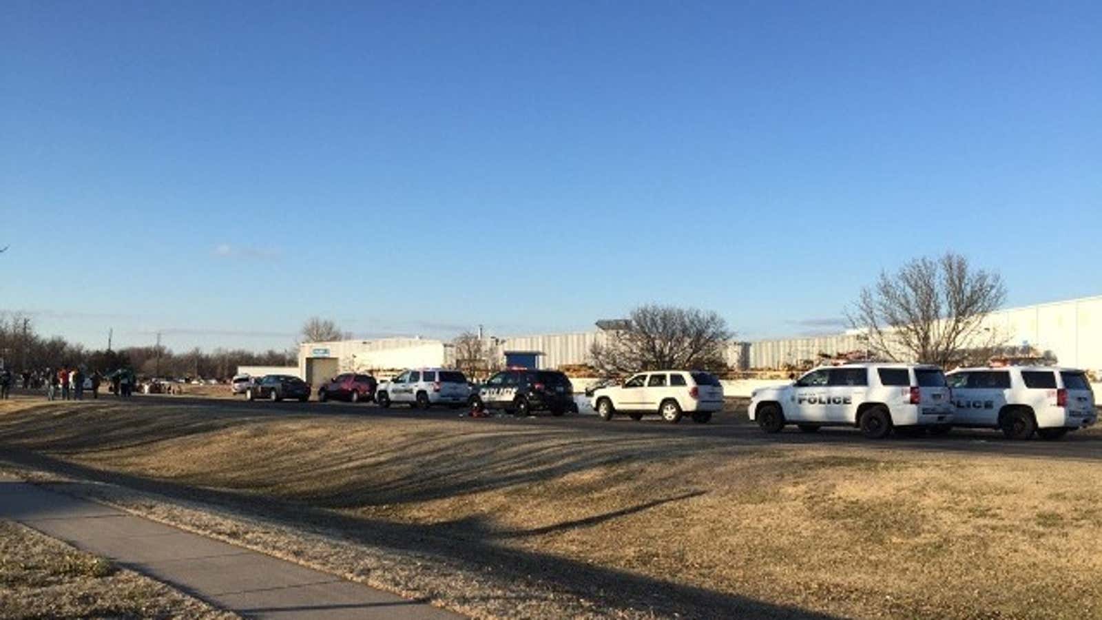 Police line the street near Excel Industries.