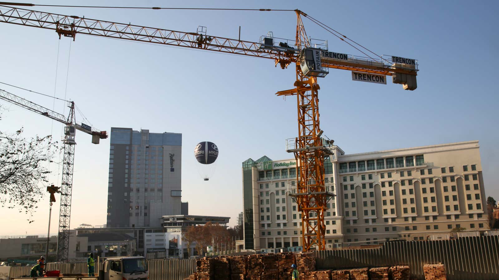 Cranes are seen at a construction site in Sandton outside Johannesburg, South Africa June 7,2016. Cranes are seen at a construction site in Sandton outside…