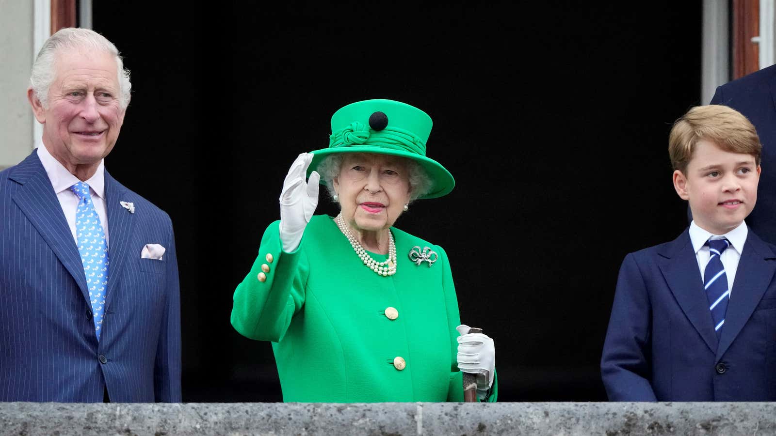 Queen Elizabeth II waves from the balcony of Buckingham Palace during her Platinum Jubilee parade.