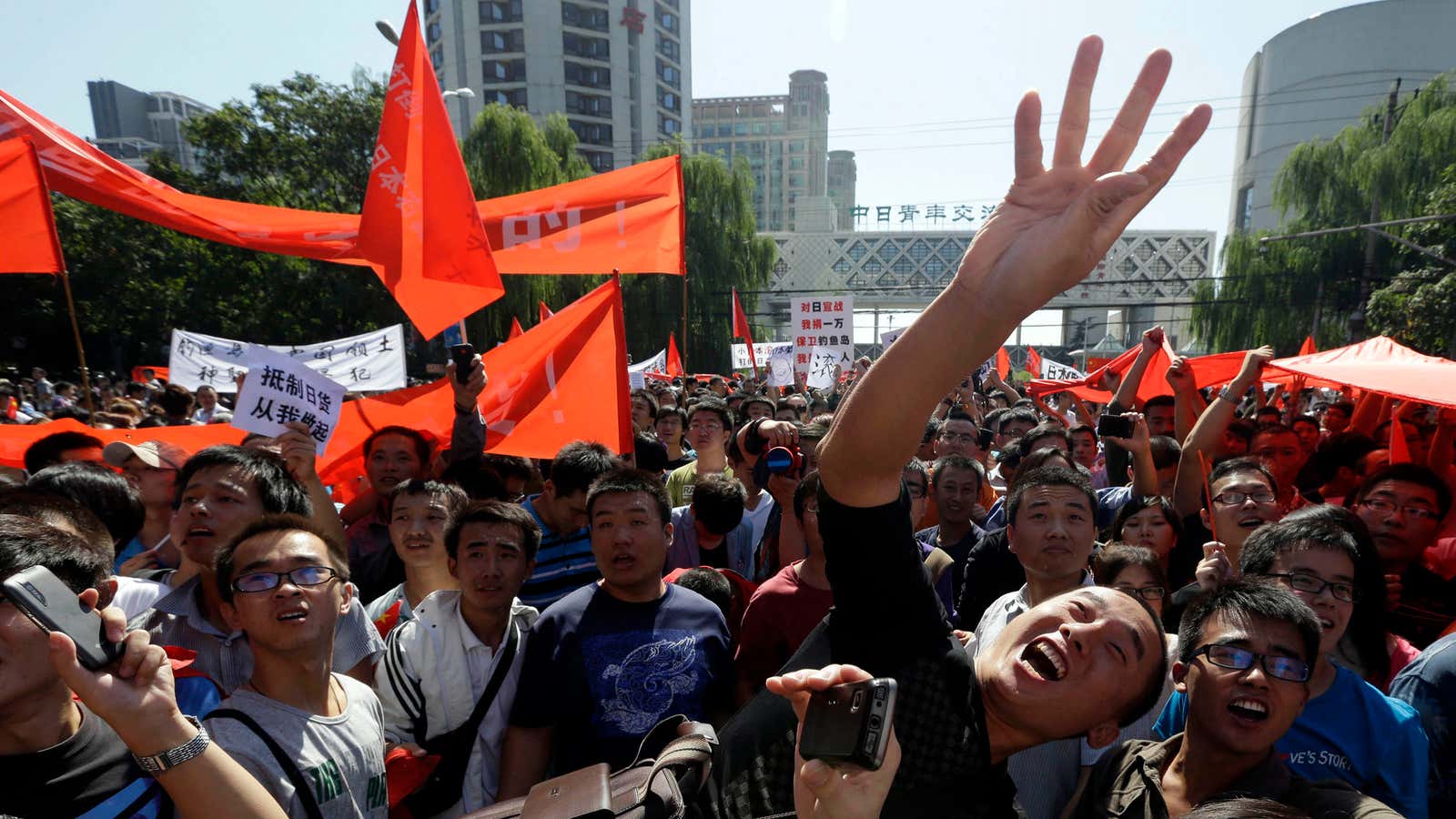 A Chinese protester flings an object—probably not a tradable good—at the Japanese embassy in Beijing.