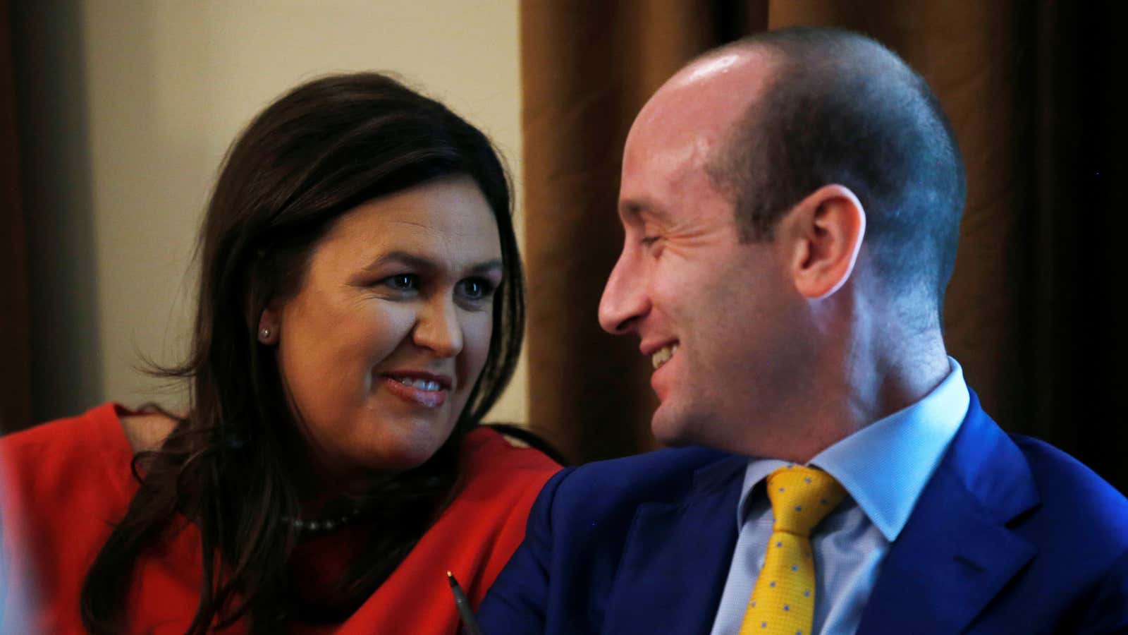 Sarah Sanders laughs with Stephen Miller in the White House, July 18.