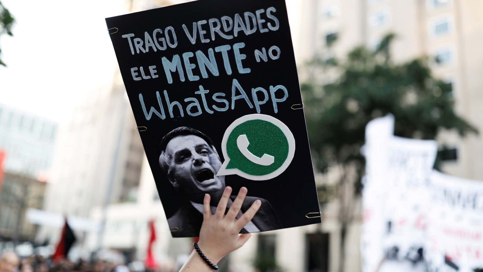 A woman holds a sign with the image of presidential candidate Jair Bolsonaro that reads “He lies in WhatsApp,” during a protest against Bolsonaro in Sao Paulo, Brazil last October.