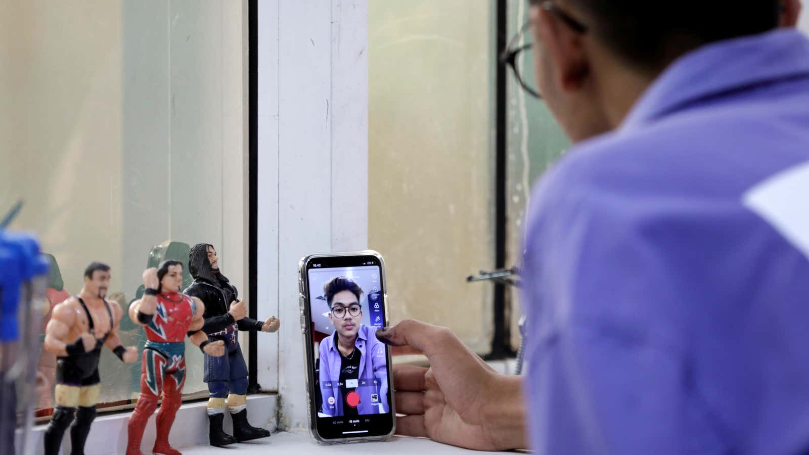 Indonesian TikTok star Sandy Saputra records a video.