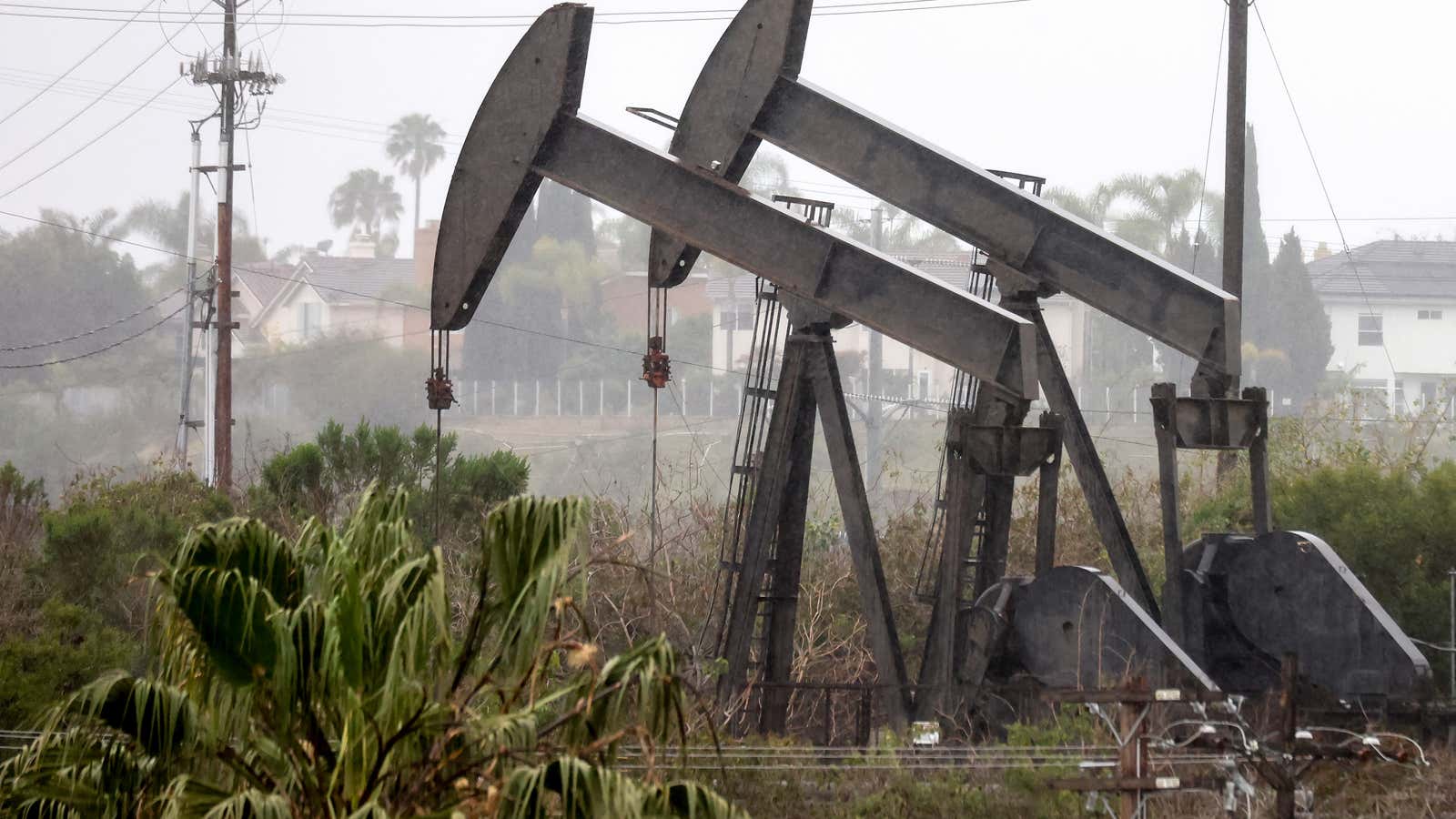 An oil pumpjack (R) operates as another (C) stands idle on March 28, 2022 in Los Angeles, California. (Photo by Mario Tama/Getty Images)