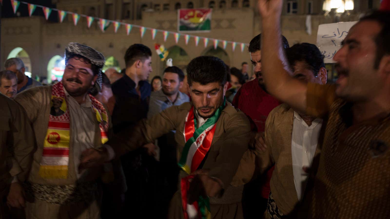 Kurdish men dance in the streets of Irbil after polling stations closed on Monday, Sept. 25, 2017. The Kurds of Iraq were voting in a referendum on support for independence that has stirred fears of instability across the region, as the war against the Islamic State group winds down. (AP Photo/Bram Janssen)