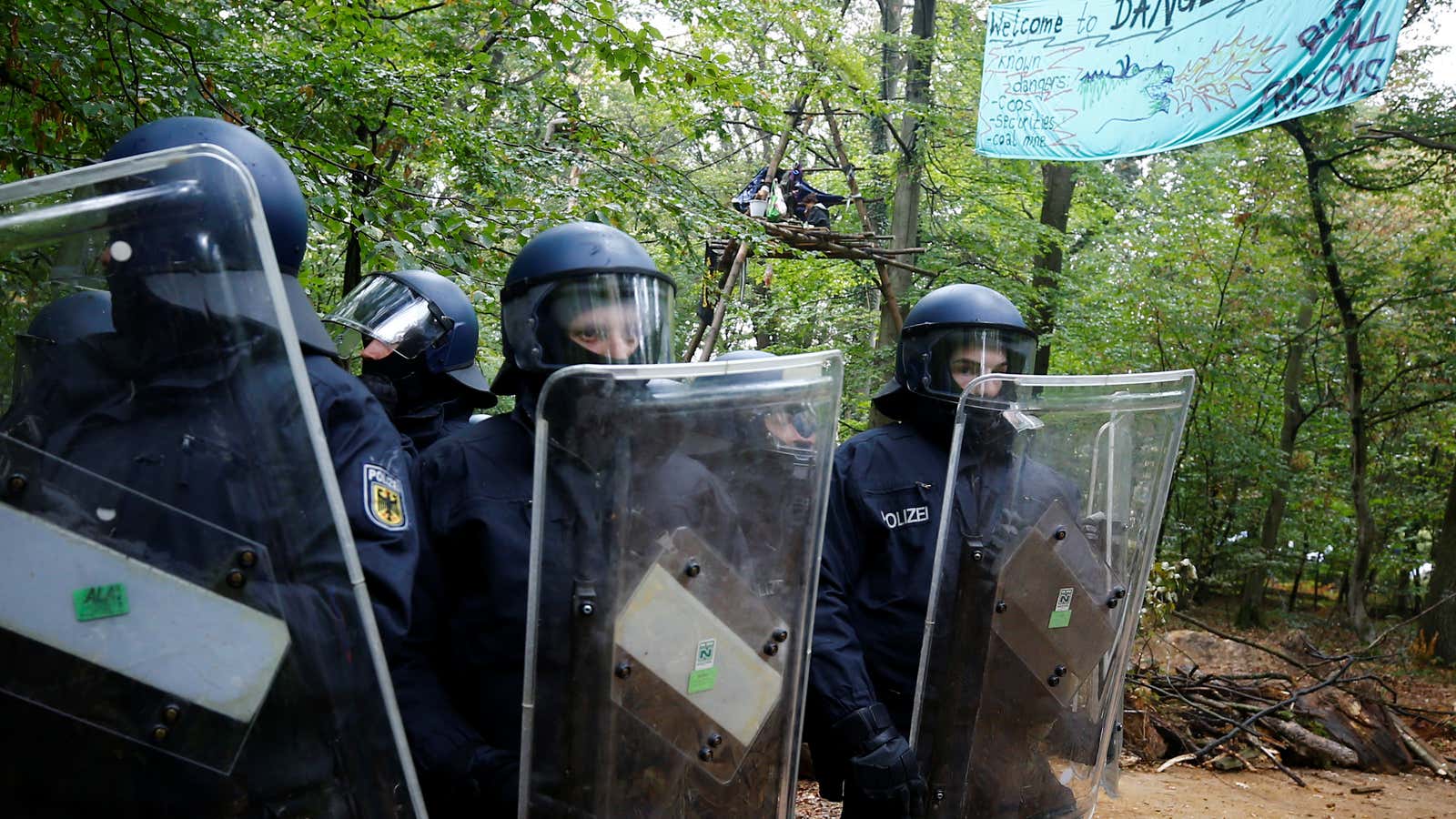 Riot police move in to clear activists out of the forest on Sept. 13.