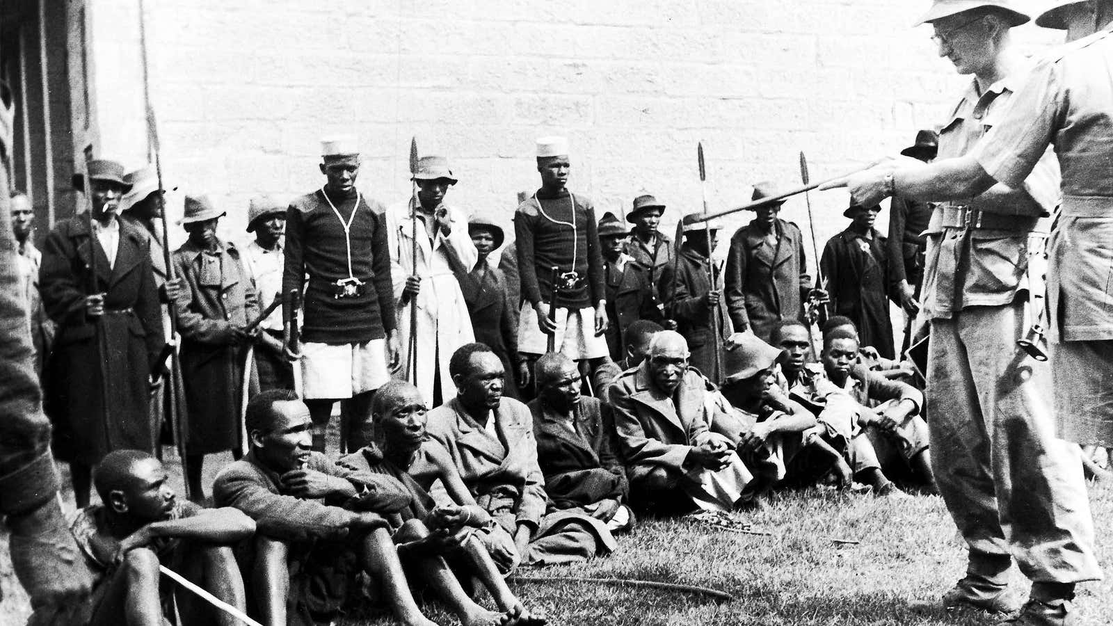 Suspected members of the Mau Mau are questioned the British in 1953.