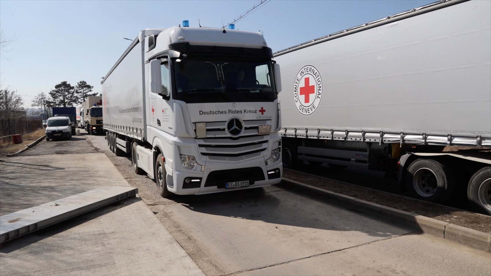 International Committee of the Red Cross trucks wait to deliver aid to Ukraine at a Romanian border crossing on March 14.