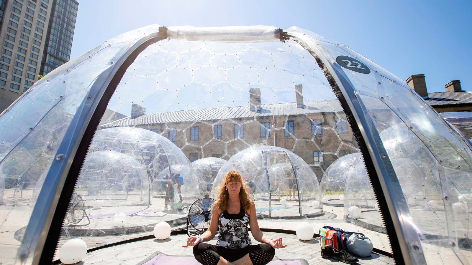 Sandra Kluge meditates before an outdoor yoga class by LMNTS Outdoor Studio, in a dome to facilitate social distancing and proper protocols to prevent the…