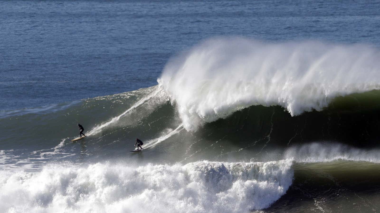 Surfers at Mavericks, near Half Moon Bay, CA.