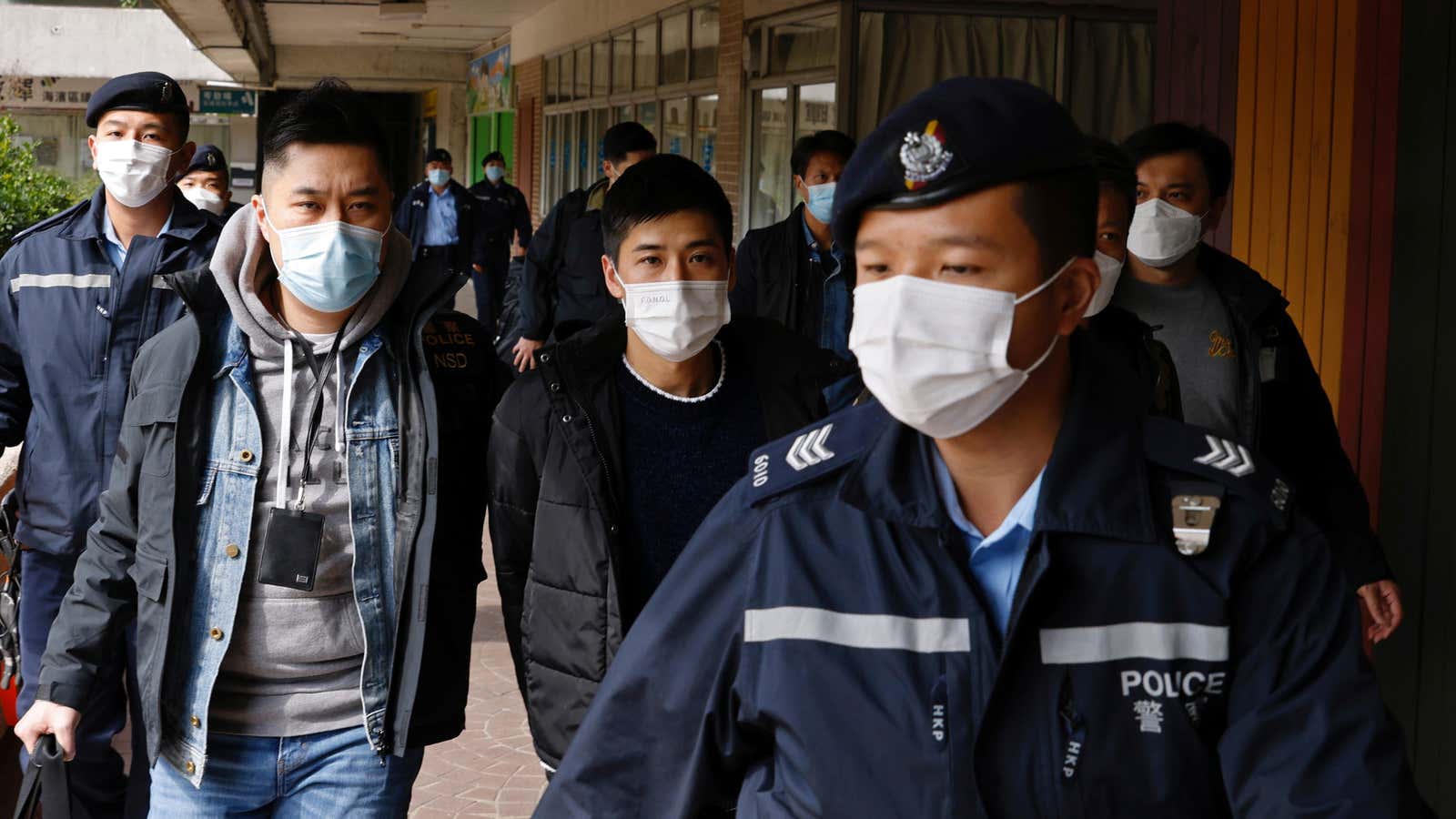 Pro-democracy activist Lester Shum is taken away by police officers after over 50 Hong Kong activists arrested under security law as crackdown intensifies, in Hong…