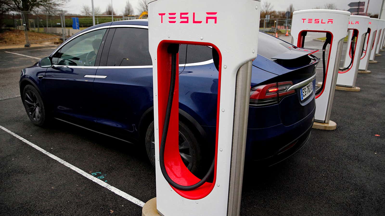 FILE PHOTO: A driver recharges the battery of his Tesla car at a Tesla Super Charging station in a petrol station on the highway in Sailly-Flibeaucourt, France,  January 12, 2019. REUTERS/Pascal Rossignol/File Photo/File Photo