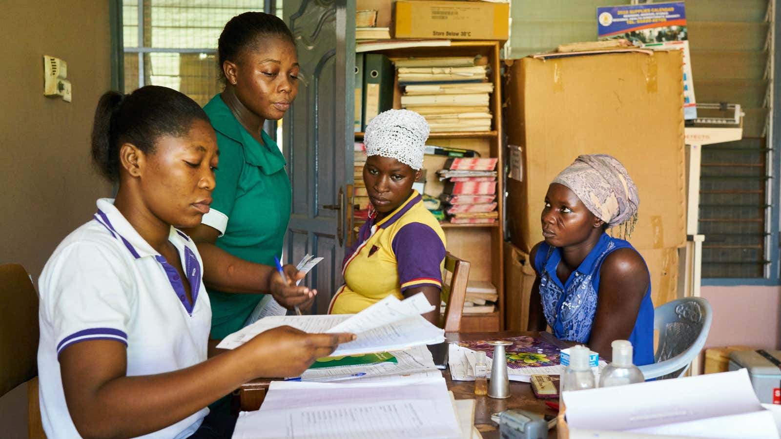 A community health worker treats a patient in a clinic in rural Ashanti.