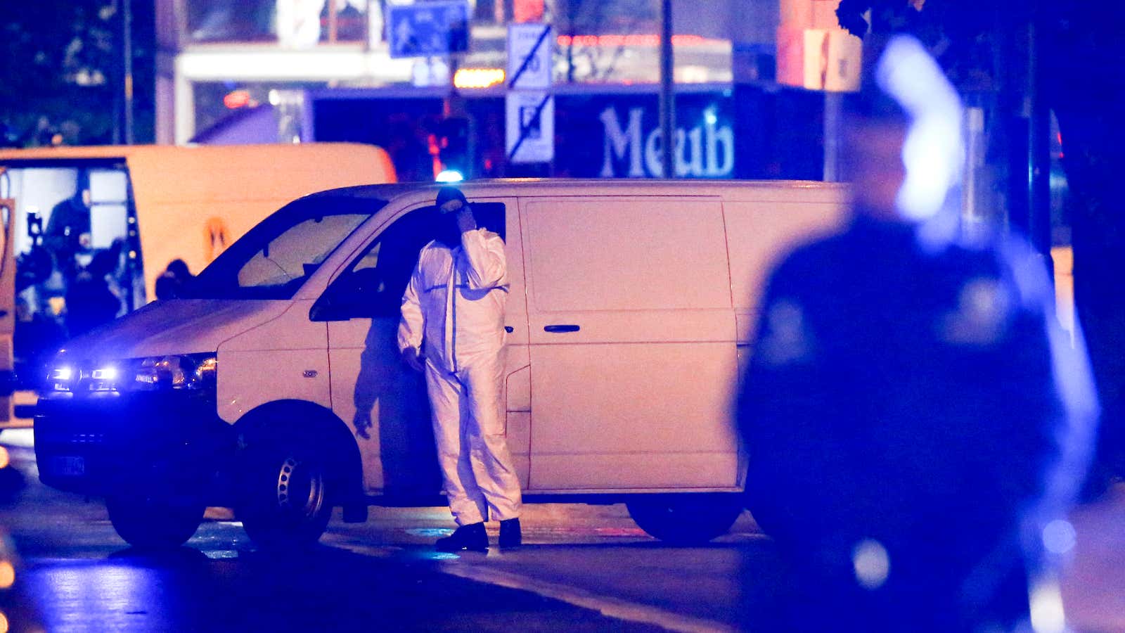 Police officers investigate the scene in the streets of Molenbeek, Brussels, Belgium, 14 November 2015.