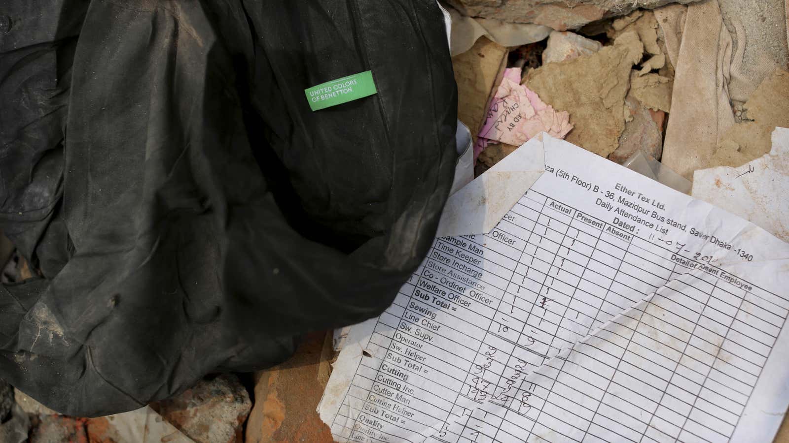 A shirt labeled “United Colors of Benneton” found in the rubble, along with an attendance sheet for workers.