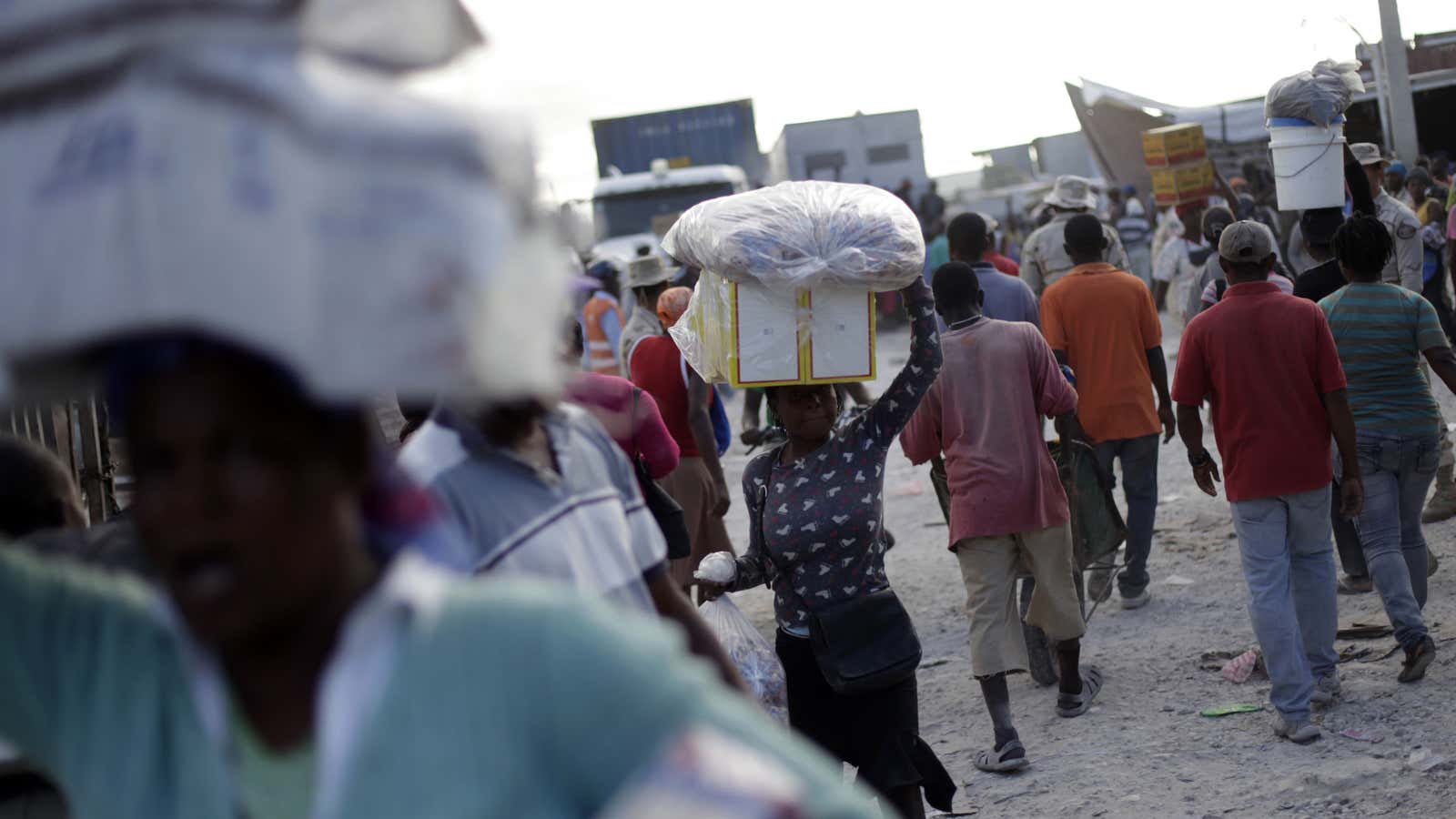 Haitian women carry goods on their heads bought in the Dominican Republic, at the border town of Malpasse, Haiti.