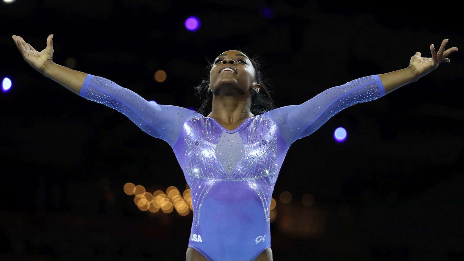 FILE – In this Oct. 13, 2019, file photo, Gold medalist Simone Biles of the United States performs on the floor in the women’s apparatus…