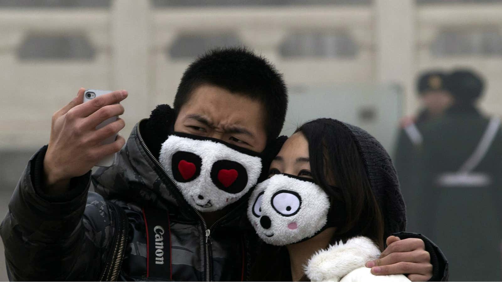 A couple poses for a photograph in the Beijing smog.