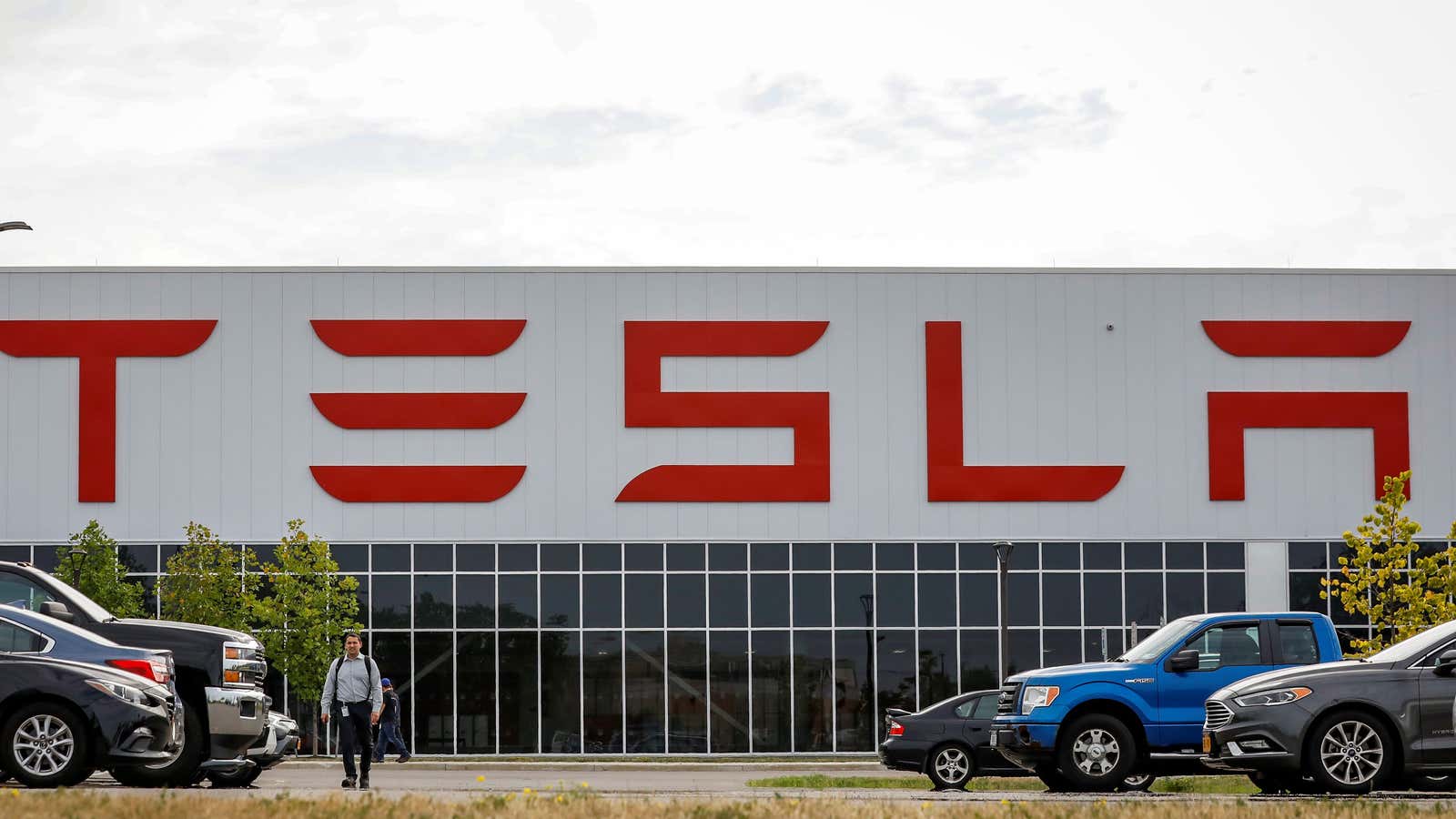 A worker is seen outside the Tesla Inc. Gigafactory 2, which is also known as RiverBend, a joint venture with Panasonic to produce solar panels…