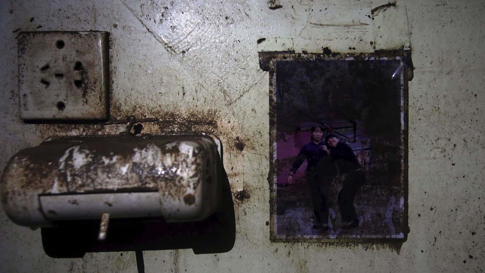 A picture is seen on the wall of a crew member dormitory inside the capsized Eastern Star cruise ship.