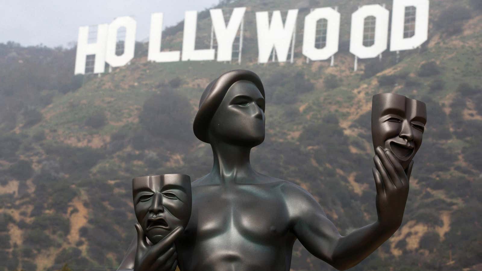 The Screen Actors Guild statue stands in front of the iconic Hollywood sign in Los Angeles.