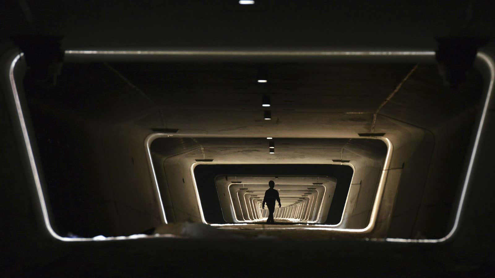 A worker walks along the foundation of a railway line in Yiwu, Zhejiang province.