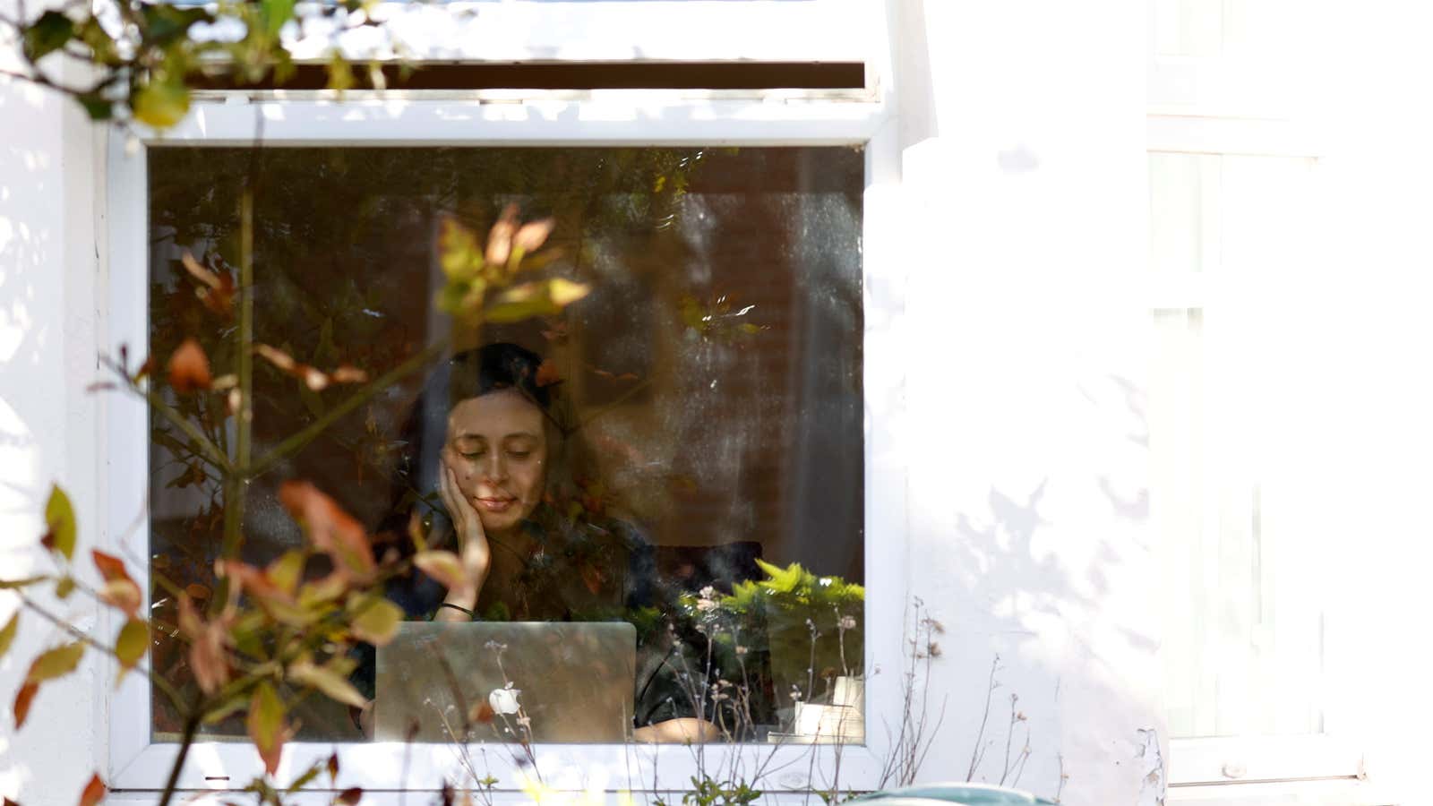 FILE PHOTO: A woman working from her computer at home is seen as the spread of the coronavirus disease (COVID-19) continues, Oxford, Britain, March 31,…