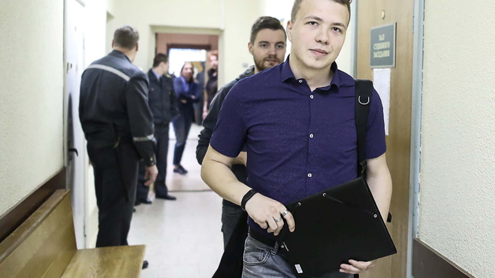 Opposition blogger and activist Roman Protasevich, who is accused of participating in an unsanctioned protest at the Kuropaty preserve, arrives for a court hearing in…