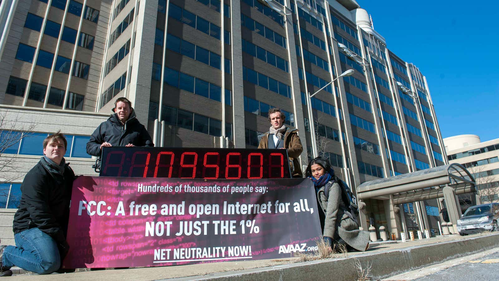 A digital sign displays a running count of net neutrality petitioners outside FCC headquarters.