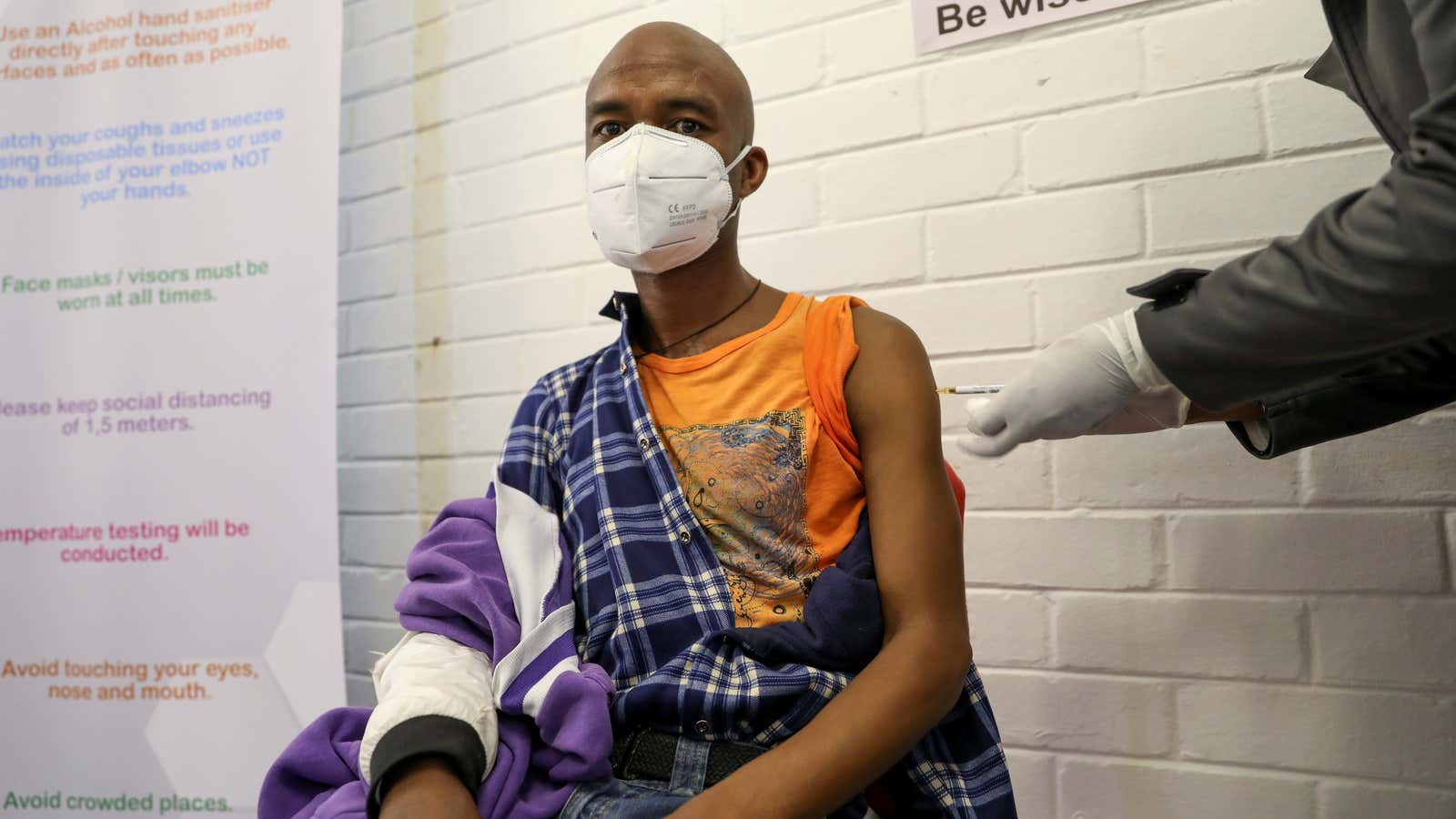 A volunteer receives an injection from a medical worker during South Africa’s first human clinical trial for a potential Covid-19 vaccine June 24, 2020.