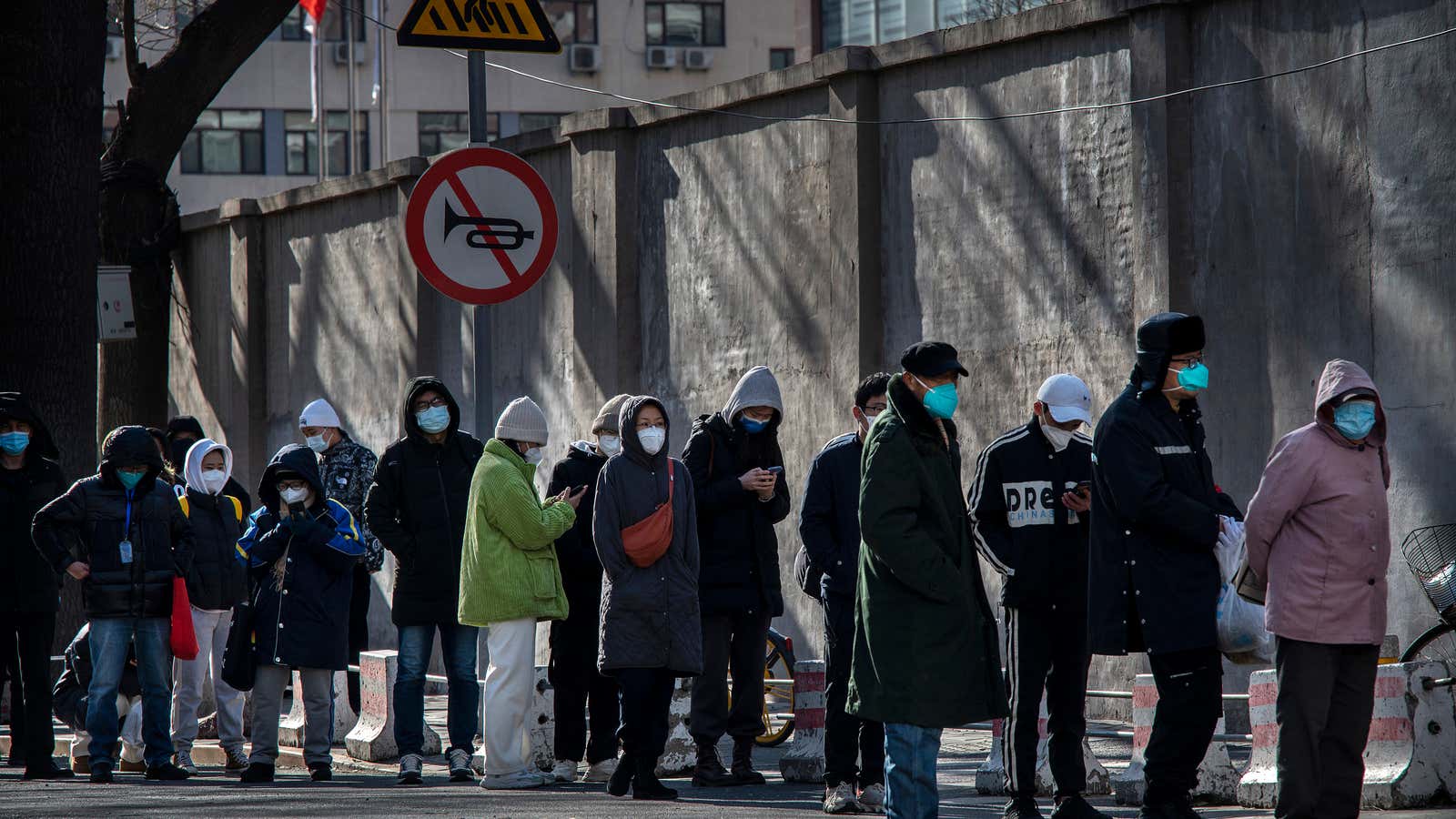 People line up outside a fever clinic at a hospital in the morning on December 11, 2022 in Beijing, China.