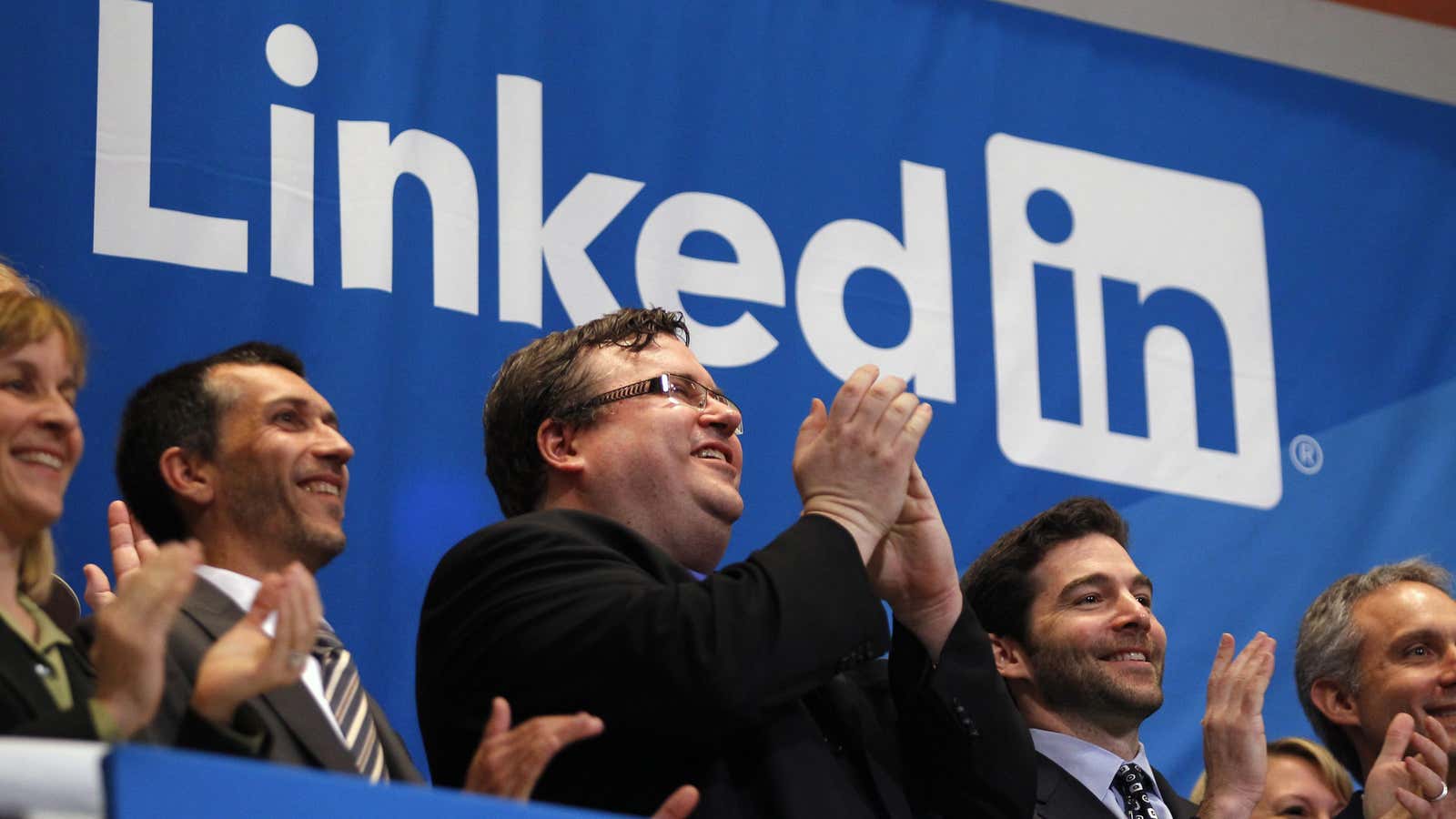 Founder of Linkedin Inc. Reid Garrett Hoffman (C) applauds with CEO Jeffrey Weiner (2nd R) from the bell balcony after the opening bell during the…