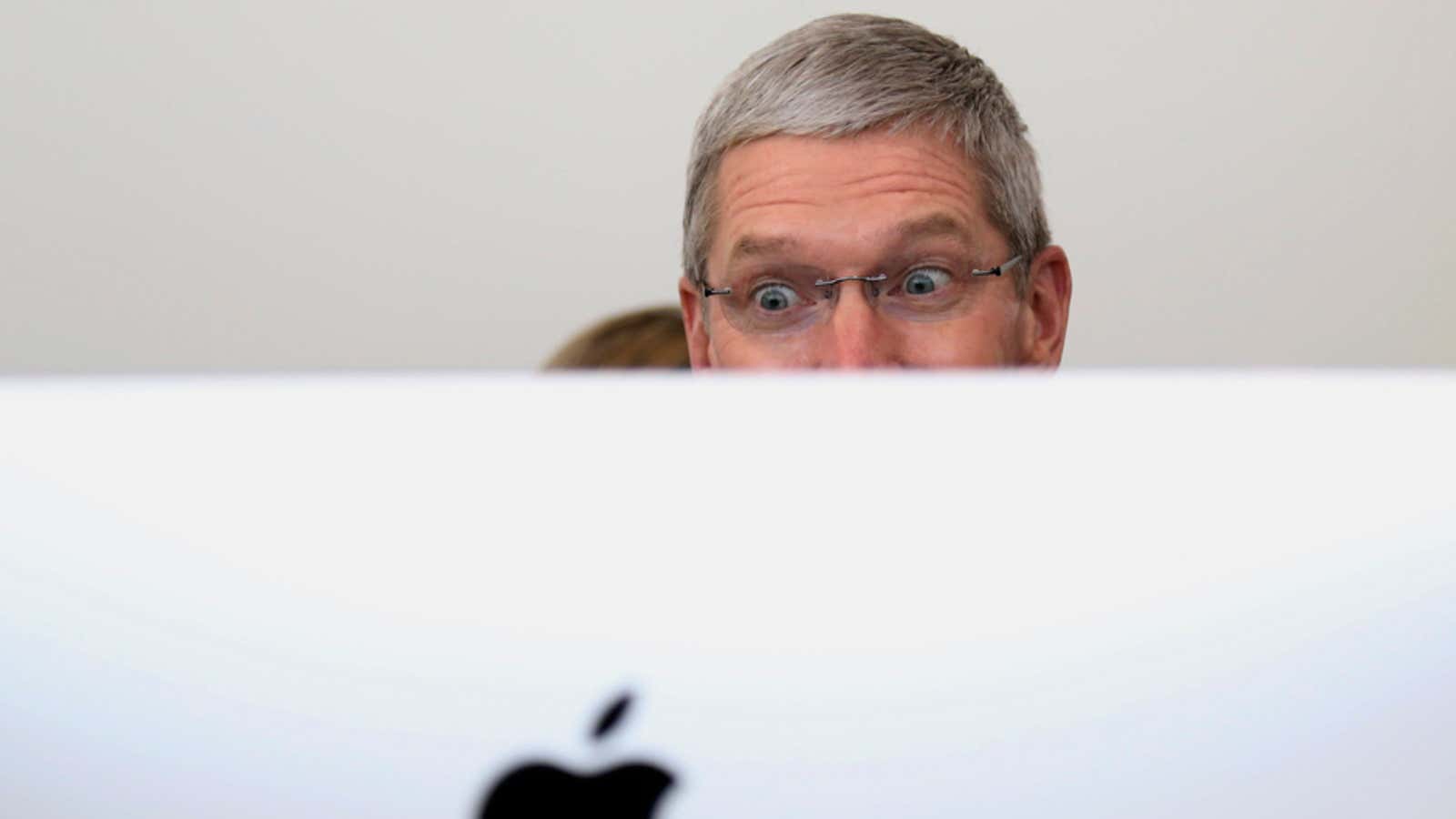 Apple CEO Tim Cook checking out one of the Macs that sold so well in 2014.