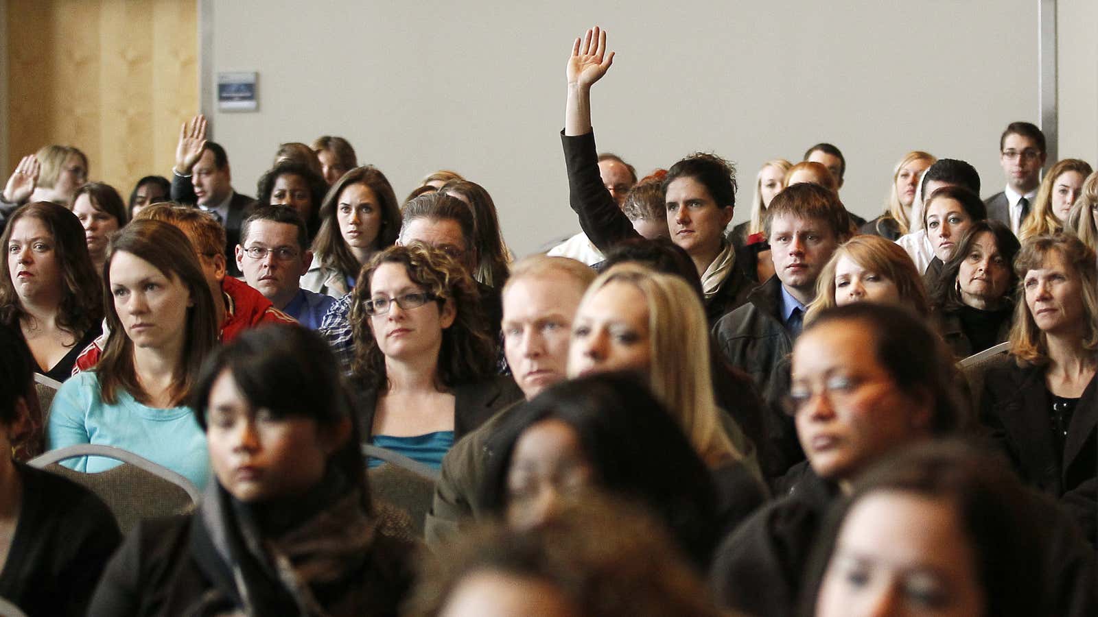 A job seeker raises his hand to ask a question at the Colorado Hospital Association health care career fair in Denver April 9, 2013. Over…