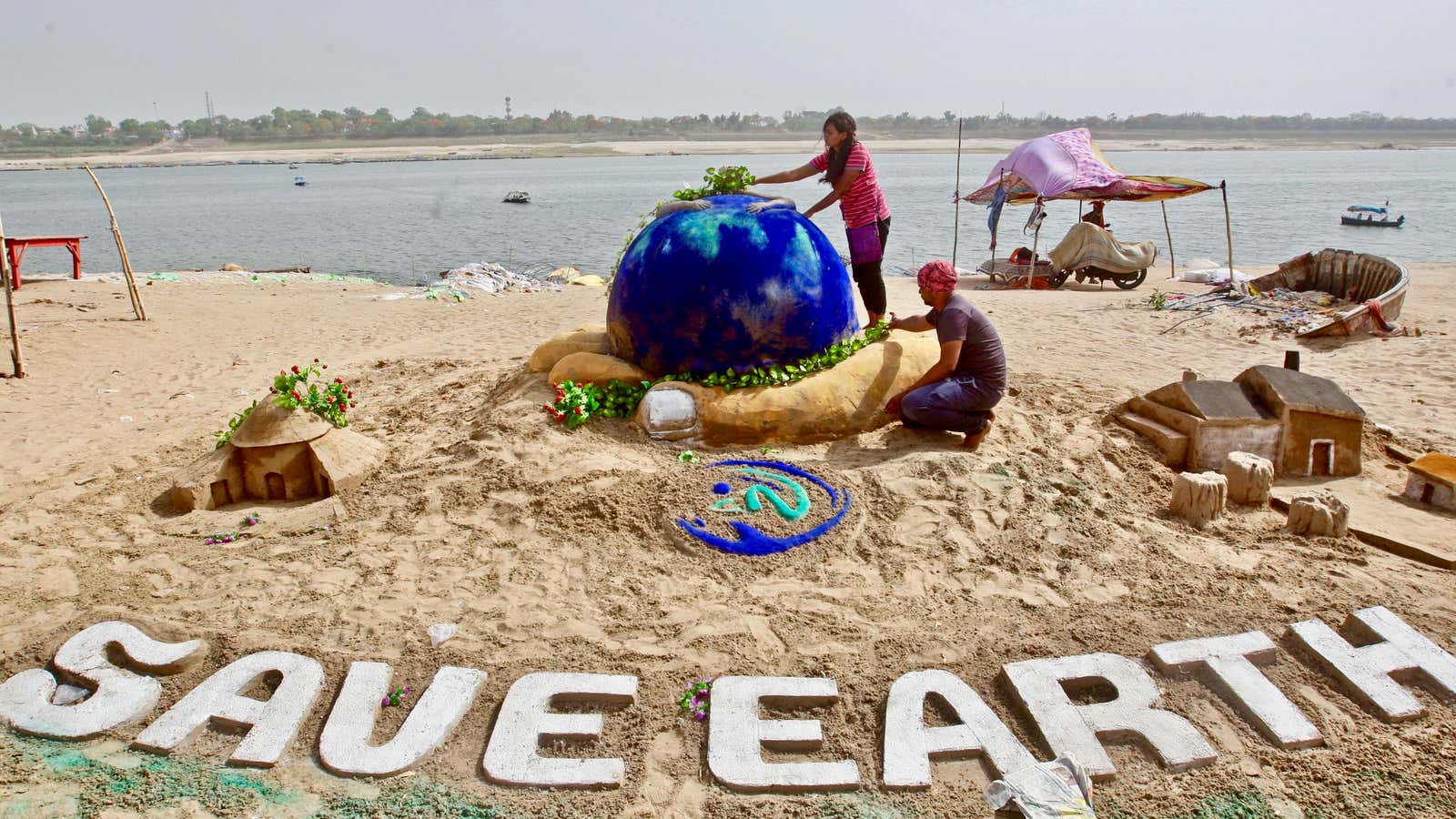 Earth Day 2018 sand sculpture on the banks of the river Yamuna in Allahabad, India.