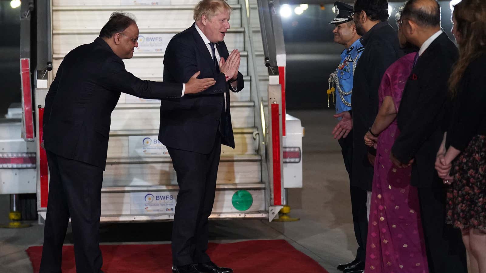 Britain’s Prime Minister Boris Johnson disembarks the plane having arrived at Indira Gandhi International Airport in New Delhi.