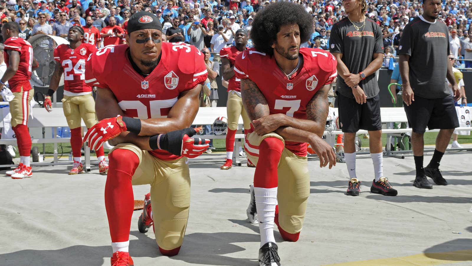 Colin Kaepernick (7) and Eric Reid take a knee.