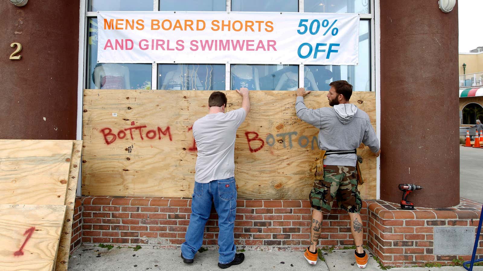 Cut your prices, then board up your shop. Preparing for Hurricane Sandy in Ocean City, Maryland.