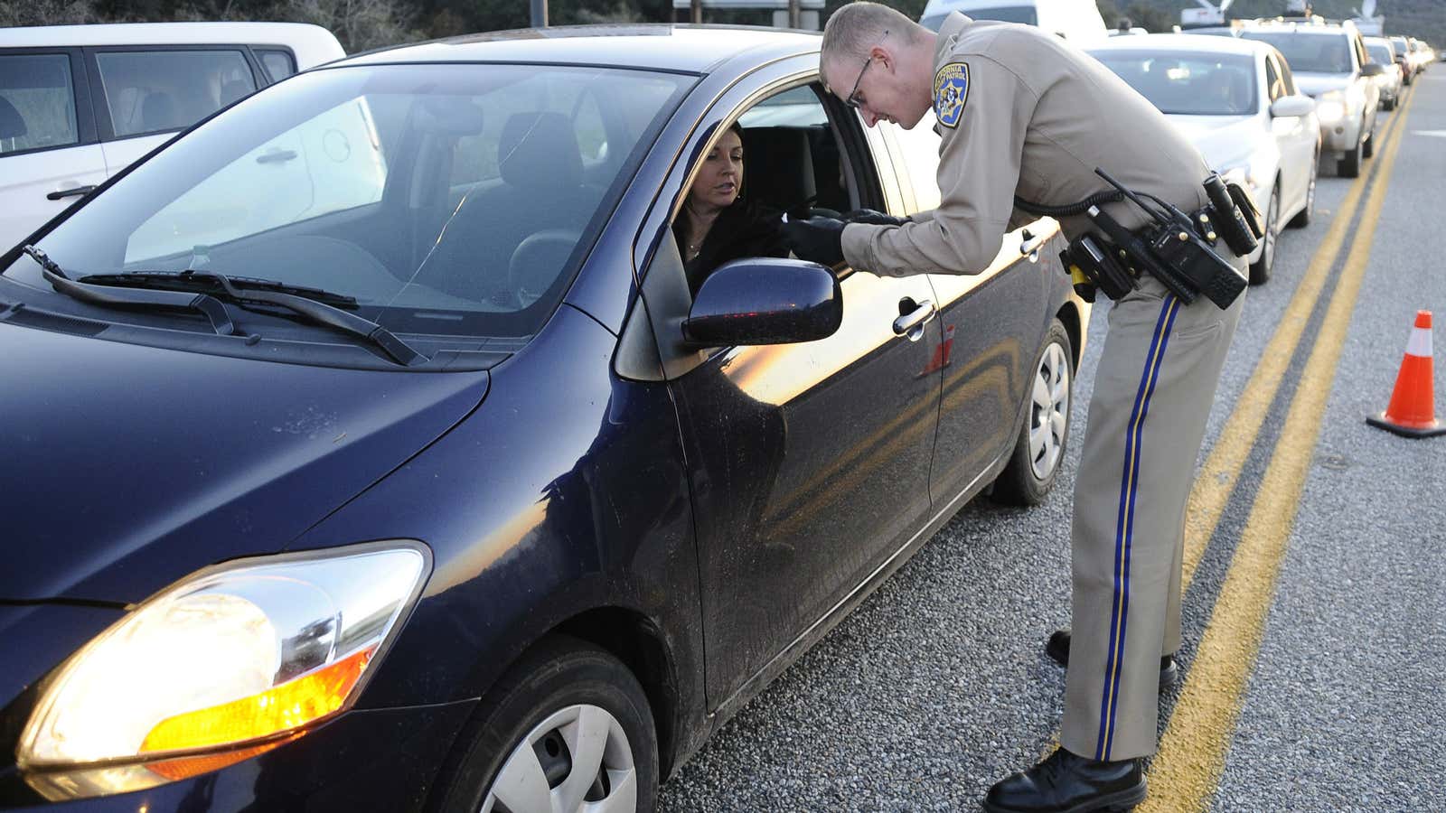 Police checking a driver’s license.