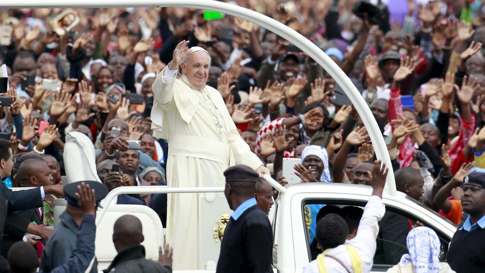 Pope Francis waves to the faithful as he arrives for a papal mass in Nairobi, Kenya.