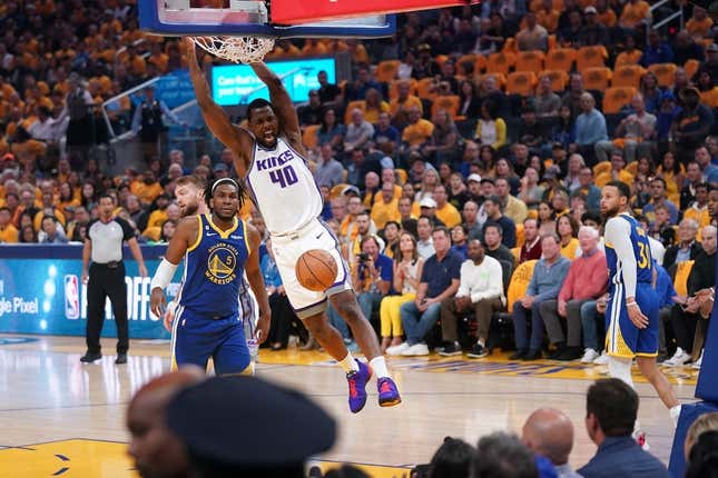 Apr 28, 2023; San Francisco, California, USA; Sacramento Kings forward Harrison Barnes (40) dunks the ball in front of Golden State Warriors forward Kevon Looney (5) in the first quarter during game six of the 2023 NBA playoffs at the Chase Center.