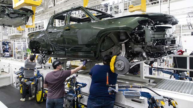 A photo of a green Rivian truck on the production line. 