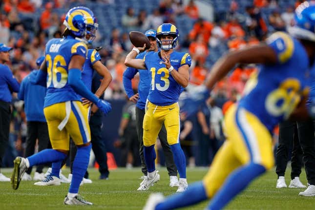 Aug 26, 2023; Denver, Colorado, USA; Los Angeles Rams quarterback Stetson Bennett (13) warms up before the game against the Denver Broncos at Empower Field at Mile High.
